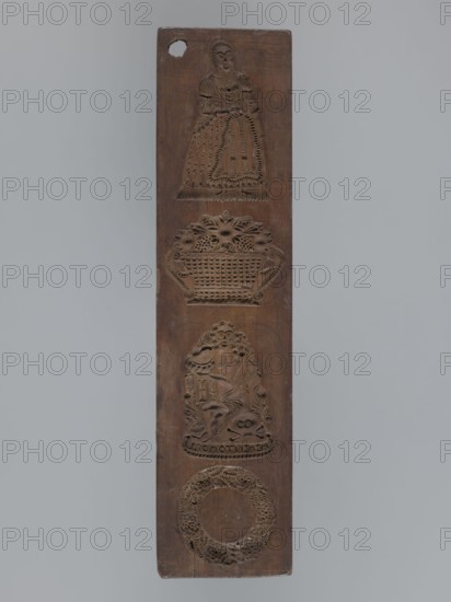 Double-sided gingerbread mould. Obverse: four images—top: female figure in a long patterned dress with low neckline; below: a basket of flowers; below: seated young naked man with long hair sitting among flowers and smoking a pipe; at his feet a skull with crossbones and the inscription MEMENTO MORI; bottom: a wreath woven from leaves and flowers. Reverse: five images of infants in patterned swaddling clothes. Materials/subject: gingerbread mould; decorative, folk motifs, floral decorations, wreaths, female figures in rich dresses, allegorical representation of Transience personification, infants. Date: 19th century. Origin: Silesia Province of Silesia, 1742–1918. Dimensions: height 36.5 cm, width 8.8 cm, depth 1.5 cm. Creator: unknown., A tall rectangular wooden panel with a vertical arrangement of carved reliefs, showing a carved figure of a person in a dress near the top, a carved basket of flowers below that, a seated figure surrounded by ornamental foliage in the middle, and a cir...