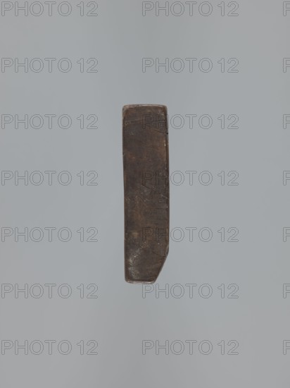 Double-sided gingerbread mould. Obverse: rectangular floral and geometric ornament — a rectangular decorative motif containing a rosette and stylised plants. Reverse: figure of the Archangel Michael in a long patterned robe decorated with a plant twig motif, holding scales in his right hand and a sword in his left; at the feet of the figure a geometric-plant ornament. Date engraved on the edge: 1806, with the letter S against the background of an anchor mark of the woodcarver or gingerbread maker — owner of the mould., woodcarver or gingerbread maker. Gingerbread, decorative art, folk art; figurative religious iconography Archangel Michael, Christianity; folk-style decorations, floral ornaments. Silesia Province of Silesia, 1742–1918. Double-sided, rectangular mould; bas-relief. Height 11.6 cm, width 30.5 cm, depth 3 cm., A single narrow vertical object with a worn, rectangular shape and rounded edges sits against a plain gray background; the object appears dark brown with lighter brow...