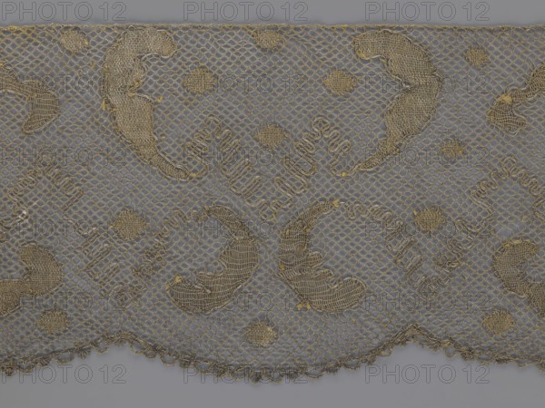 Lace fragment, lace, 18th century, Europe, fabric, width 20 cm, length 120 cm, A piece of delicate net fabric with a repeating decorative pattern, showing a scalloped lower edge and a narrow straight top edge, rendered in shades of beige and gold against a muted gray background; the netting forms a diamond mesh with thicker embroidered outlines creating a mix of curved paisley-like shapes, small oval motifs, and textured fill areas, all in varying warm beige and metallic gold tones, with subtle shadows and highlights that emphasize the woven texture and slight irregularities in the embroidery.