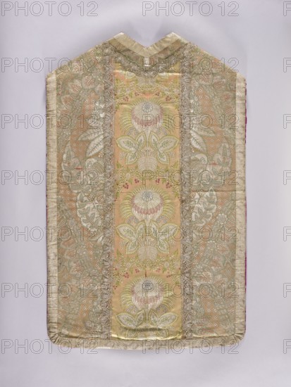 Chasuble, Chasuble made of two types of lace fabrics: the front and sides of the back are a silver-colored fabric embellished with a pattern of large plant motifs. The column on the back is satin, straw fabric embellished with colored silk motifs, large fantastic flowers and leaves growing from a small basket. The columns are trimmed with silver lace. The edges of the chasuble are trimmed with wide silver lace. Red silk lining. Liturgical vestment; churches and chapels furnishings; sacred art; liturgical vestments; flowers and plant ornaments; church paraments. Measurements: length 106.5 cm; width 66 cm back; report height 66 cm; columns: height 30 cm width unknown. Date: 1st quarter of the 18th century front and sides of the back: 1720–25; column on the back: ca. 1715. Place of origin: France., A textile panel with a tall, narrow shape and a pointed top, displaying an ornate symmetrical floral pattern; the center panel features a repeating stylized flower motif with layered petals and...