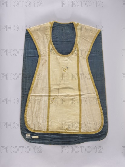 Chasuble, Liturgical vestment made in the 2nd half of the 18th century. Constructed of three types of silk fabrics with an embroidered column at the front. The front column is white silk grosgrain, embroidered with silk threads in patterns of small floral sprigs; three sprigs are placed sparsely and appear to have been cut from another piece and added. The column at the back and the neckline are silk weft-weave brocaded with silk yarn and silver thread in a striped pattern, with a wavy floral tendril and small floral sprigs. The sides are cream-colored striped silk. Trimmed with yellow silk braid. Cotton lining, green on the front and navy blue on the back. Decorative motifs: flowers, leaves, plant ornaments. Function: liturgical vestment/church parament. Dimensions back: length 98.5 cm, width 68 cm. Place associations: Poland; France back., A garment laid flat on a neutral light background, showing a sleeveless outer piece with a deep rounded neckline and a flared lower shape; the cen...