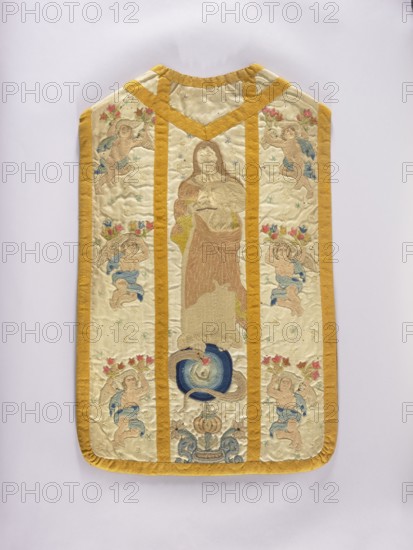 Chasuble, Liturgical vestment, 18th century, Poland. The front column is embroidered with stylized flowers and angels; the rear column: in the center, a figure of the Madonna on the moon; on the sides, angels holding flowers; background covered with tiny stars. Trimmed with smooth woolen braid. Predominant colors: white background with light pink, blue, and sand ornament. Linen lining. Length 96 cm, width 61 cm back., A rectangular embroidered textile with rounded bottom corners and a notched top, bordered and divided by a mustard yellow trim; the central panel shows a standing robed figure in muted beige and brown tones above a circular motif in deep blue and lighter blue, with a coiled serpent-like form in tan; the side panels each feature a group of cherubic figures in pale skin tones with blue drapery and floral crowns in reds and pinks, scattered small star-like embroidered motifs in pale blue and green across a cream background, and decorative scroll elements in blue and tan near...