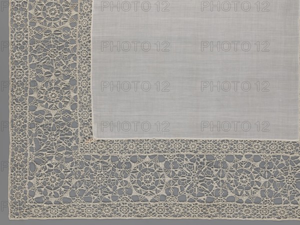 Doily, geometric ornaments, rosettes ornament, doilies, smooth center. Edge made of white linen lace with rosette motifs: large rosettes in the center and rows of small rosettes on the edges, punto in tela lace, ca. 1600, Italy, lace, fabric, height 79 cm, width 70 cm, A corner of a rectangular, light-colored fabric panel with a plain central area and an ornate openwork border; the plain area is a soft, pale off-white with a fine woven texture, and the border is an intricate lacework in a slightly warmer cream tone featuring circular motifs, radial patterns, and interconnected looping threads set against a muted gray background.