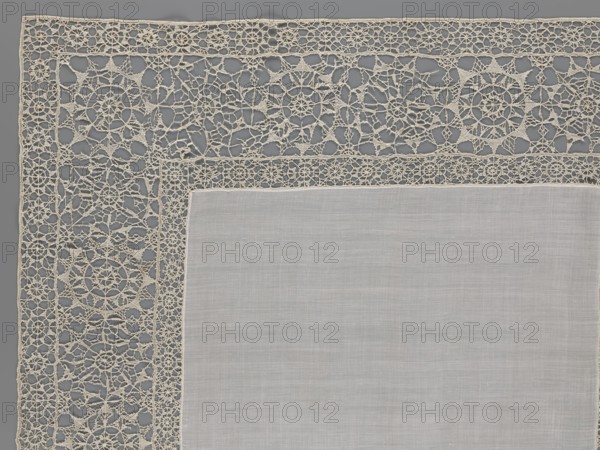 Doily, geometric ornaments; rosettes ornament; doilies; smooth center. Edge made of white linen lace with rosette motifs: large rosettes in the center and rows of small rosettes on the edges; punto in tela lace; ca. 1600, Italy; lace, fabric; height 79 cm, width 70 cm., A section of a square textile with a plain central panel in pale gray-beige surrounded by an ornate lace border in off-white; the lace border features a repeating pattern of circular and star-like motifs connected by delicate threadwork and open spaces, with a narrower inner strip of denser lace joining the plain center to the wider decorative outer band, all set against a cool medium gray background.