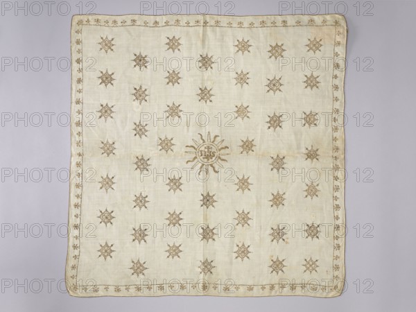 Velum, Velum made of white linen fabric with a rare plain weave 25 warp threads and 30 weft threads per 1 cm. Embroidered with gold thread on a silk backing with pierced stitches. Double-sided embroidery, equally careful on the right and left sides. Metal thread woven on thick silk thread. In the center, in a radial circle, the IHS monogram with a cross. In the field of the napkin, radial rosettes arranged in 6 rows, 7 in each, offset. Small stylized ornaments flower branches? in the border. 16th/17th century, Poland. Liturgical vestment. Height 66.5 cm, width 65 cm., A square cloth laid flat on a pale lilac-gray background, the fabric is an off-white or cream color with a subtle woven texture and slightly uneven edges. The cloth is decorated with a repeating motif of ornamental sun-like shapes in a light brown or tan thread, arranged in a regular grid across the surface, and a larger central sun motif with radiating rays in the same color. A narrow embroidered border of small floral o...