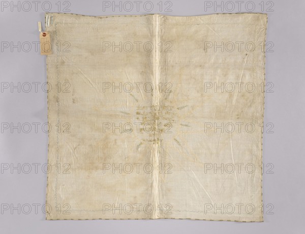 Church napkin. Napkin made of linen with a fairly dense weave. In the middle an inscription embroidered with gold thread on a silk ribbon: Whoever eats my body / and drinks my blood has / eternal life And / I will raise / the last / day / in John in the year 6 / in 54. Around it is an appliquéd narrow grosgrain ribbon in cream and beige forming a circle with three-pronged rays 10, and within them are small blue and gold embroidered rays. An identical grosgrain ribbon in three tones of blue is sewn around the edges of the napkin. The ribbons, approximately 8 mm wide, date from the second half of the 18th century, but the inscription was created earlier, as the sewn-on ribbon partially obscures its lower letters. Fabric density: 30 warp and weft threads per cm. 18th century, Poland. Materials: linen, silk ribbon, gold thread, grosgrain. Dimensions: height 76 cm, width 80 cm., A square textile laid flat on a light gray background, appearing off-white to cream in color with areas of subtle...