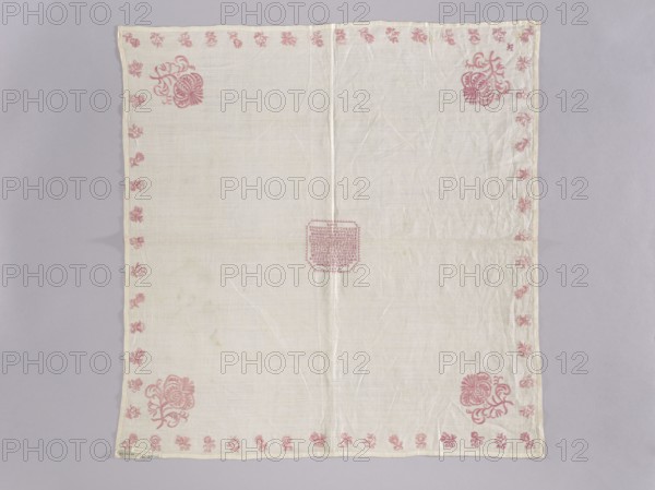 Velum made of white linen batiste; flat, pierced, double-sided embroidery. In the center, in a cartouche, an embroidered inscription in German and the date 1700. Border of small floral sprigs, with one large floral sprig in each corner; in one corner a small monogram EN under a crown. Ornament color light raspberry. Stitches: satin, cord, split, cross; letters and numbers are made with crosses, each cross on three warp threads and three weft threads. Subject: flowers, leaves, plant ornaments; sacred art liturgical vestment., Date: 1700. Place of origin: Silesia. Dimensions: height 77 cm, width 75 cm. Repossession, A square piece of light-colored fabric laid flat against a pale gray background, with a visible vertical crease down the center and subtle wrinkles across the surface; the fabric has a decorative border of small floral motifs in a pink hue running along all edges and larger stylized pink floral designs positioned near the corners, with a small pink embroidered geometric patch...