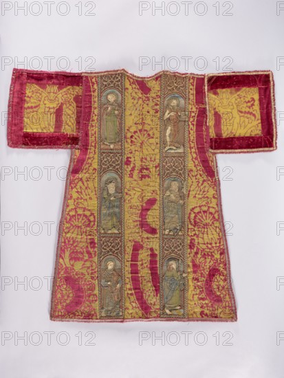 Half of a dalmatic. Preserved half of a dalmatic made of red, patterned, large-scale velvet with pomegranate and thistle flower motifs brocaded with metal thread. Two panels with figures of saints are sewn onto the fabric, three in each stripe. Figures of saints with attributes placed in semicircular arcades: on the right panel — St. John the Evangelist with a chalice, St. John the Almsgiver with a staff and a book, a deacon with a book; on the left panel — St. John the Baptist, a very damaged saint with a halberd, a saint with a spear possibly St. Maurice. Embroidery in metal threads Cypriot gold and multicolored silk; stitches include flat laid on a thread base, banner, Burgundy shaded gold, Cologne, cord, and split stitches. The figures of the saints are executed on a separate base and applied; faces and hands are made of applied silk satin. Metal threads held with silk yarn two or three threads each. c. 1500, Italy fabric. Liturgical vestment. Height 89 cm, width 95 cm., A garment ...