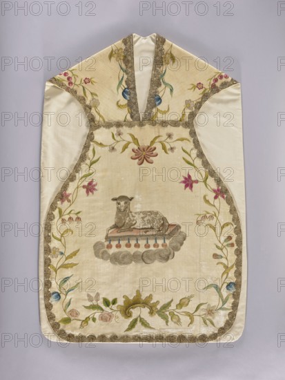 Chasuble, Front center: an embroidered lamb lies on a book from which seven seals emerge, surrounded by clouds; delicate floral tendril around the edges. Back: John the Baptist baptizing Christ, above them in a radial rim a dove. John the Baptist with a cross bearing a ribbon inscribed ECCE AGNUS DEI. Bottom edge: a basket of flowers with a long floral tendril. Pastel colors. Trimmed with gold lace. Cotton lining. Lined with thick canvas. Made of cream silk grosgrain, lined with linen canvas. Embroidery in silk thread and metal-braid thread in shaded chain stitch. Edges trimmed with bobbin lace. 18th century, Poland. Liturgical vestment. Dimensions: length 113 cm, width 69 cm back., An off-white textile garment with a pointed top and rounded bottom is displayed flat against a pale gray background; it features a central embroidered scene of a reclining lamb in muted brown and gray tones resting on a small cushion set atop a stylized cloud in soft gray, with a row of small round tassel-l...
