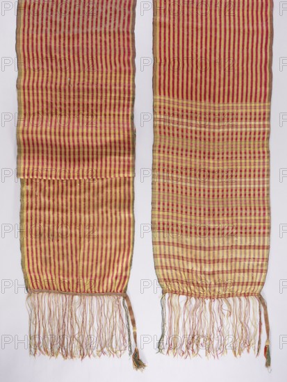 Belt, 19th century, Russia . Geometric ornaments; reversible kontusz belt for Polish men's costume. The belt ends: one 111 cm long, the other 69–70 cm long, are checkered with stripes in red, gold, straw, and light olive. The middle of the belt has longitudinal stripes in red and gold. A long silk fringe is sewn on, decorated with a sewn-on selvedge at the point of attachment. Clothing accessory; length 412 cm, width 41.5 cm., A pair of long woven textile panels with vertical stripe patterns and fringed ends, shown side by side against a pale background; the fabric displays alternating red and yellow stripes that form a denser checked area on one panel, with the woven threads creating subtle variations in tone; the lower edges end in tangled fringe in mixed colors including red, yellow, and green, and each panel has a narrow selvage with darker edging.