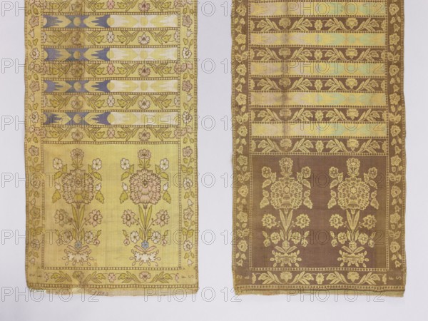 Kontusz belt. Bipartite heads with elongated floral bouquets; transverse belts with a floral tendril ornament alternating with geometric bands bearing elongated rosettes. Floral tendril border. Colors: straw, cream, pink, sky blue, green, white, navy blue. Signed at the bottom in the heads: FS lying. At the bottom edge of one end an illegible inscription possibly 1000. 2nd half of the 18th century; Kraków, Polish national costume accessory. Length 357 cm, width 36.5 cm. Materials/technique: woven/embroidered belt; floral and plant ornamentation; four-sided belt design; men's clothing accessory kontusz belt., Two long rectangular fabric panels lie side by side on a light neutral background, each panel showing a repeating floral and geometric woven pattern. The left panel is primarily pale yellow with accents of muted blue, pink, and green, featuring vertical bands of stylized leaves and floral motifs and a larger section with two vertical floral bouquets framed by a narrow decorative bo...