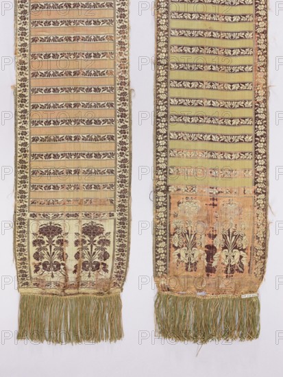 Kontusz sash, Szczepan Filsjean Manufactory Kobylka; belt manufacturer; 1787–1794. Silk kontusz sash, double-sided. Bipartite heads with bouquets of flowers carnations rooted and tied with ribbon, alternating with smooth stripes and floral twigs. Trimming with floral twig. Colors: brown, cream, olive and crimson. Sew-on silk fringe in green, straw and ochre. Ornament - Heads: two floral bouquet motifs each. - Middle: alternating transverse shelves, plain and with a floral tendril motif. - Borders: vertical and horizontal with a tendril motif, borders: checkerboard. Colors - Present: cream-pink background of heads, borders and shelves with tendril, brown ornament; plain crimson-pink shelves. - Reverse: right, except for plain green shelves. Signed in the corners of one of the heads, under the main motifs: S. Filsjean. Weave density: approx. 17/48 x2. Bouquet motifs similar to motifs in other contemporary belts. Date/place: 1787–1794, Kobylka, Poland. Function: clothing accessory for nat...