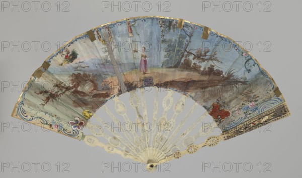 Fan, Double-sided fan with an ivory frame and painted paper covering. The obverse most likely depicts a marriage proposal: around a young lady seated in a park setting, dressed in a French-style dress, stand a boy playing a flute, a shepherd holding a lamb, a gardener, and a gardener with a basket of fruit; the lady is assisted by a girl sitting on a stone. On the left, a young man with a bouquet of flowers and a dog; on the right, a girl with an open birdcage on her lap and a boy holding a small bird. Cupid, holding a garland of flowers, hovers above the figures. The scene is surrounded by an ornament of colorful flowers and gold Rococo motifs. On the reverse, edged with a delicate blue Rococo ornament, a shepherdess wanders alone in a park landscape. In places where the leaf's cover is torn, elements cut from colored graphics are glued in: on the right side two caricatured male profiles; near the upper edge a girl's silhouette in a landscape, bearded men holding a ribbon with a Chine...