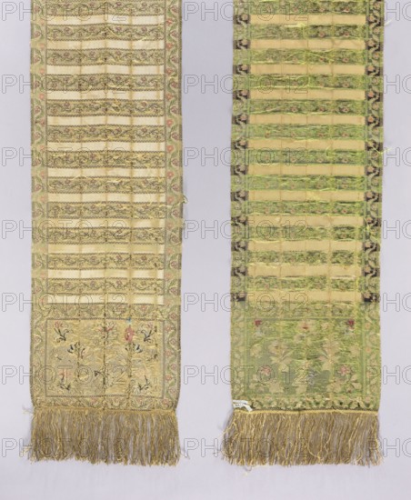 Kontusz sash, Royal Silk Manufactory in Grodno; silk fabric and belt manufacture; 1768–1780. Semi-solid kontusz sash, single-sided. Single-piece heads with a floral pattern and alternating transverse stripes—some smooth, some with a floral tendril pattern. Floral tendril edging. Sewn-on golden fringe. Colors: gold, green, pink, cream, blue. Ornament - Heads: projections of flower or fruit branches; four on each side in antithetical arrangement, two in the middle arranged asymmetrically. - Center: transverse shelves alternating plain and with a floral tendril motif. - Borders: vertical and horizontal with a floral tendril motif; borders with interlacing lines or a snake. Colors - Background of heads, edges and shelves with tendril: gold; ornament: green, pink and blue; plain shelves: cream. Weave density: in heads, edges and shelves with tendril approx. 16/32 x2; in smooth shelves approx. 46/32. Place of origin: Grodno Grand Duchy of Lithuania, Poland. Function: men's clothing accessory...