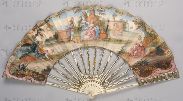 Fan, painted from carved ivory. Feathers decorated with gold and silver metal foil and sequins. Cover feathers with openwork decoration featuring a motif of ovals, shells, and floral sprigs. Right side of the cover painted in gouache with a pastoral scene in a park landscape in whitened colors; dominant colors blue sky/background and pink architectural elements and figures' clothing. Left side of the cover shows a landscape with mountains in the background. Scenes framed by a delicate gold-painted Rococo ornament. 2nd half of the 19th century; possibly 18th century; France, Europe. Pastoral scenes, landscapes, plant ornaments; fashion accessory fan. Height 27 cm., A hand fan with a painted leaf showing a pastoral scene in soft colors including pink, blue, green, brown, gold, and cream, featuring a group of people in period dress seated and standing among rocks and foliage, a seated figure in a pink dress at one side, a figure in blue and yellow clothing near a small animal, and a few o...