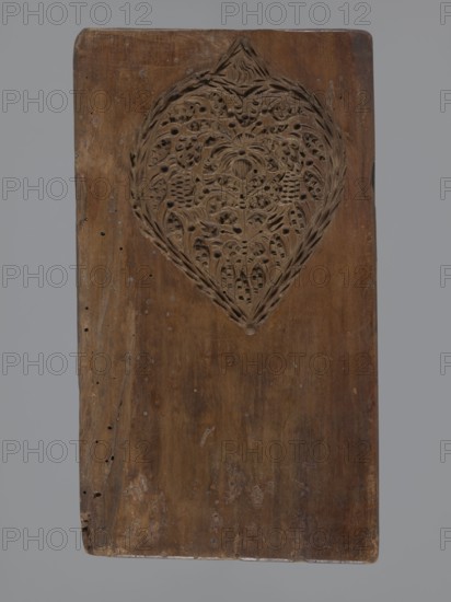 Double-sided gingerbread mould. Obverse: baptism scene; reverse: floral ornament. Genre scenes, gingerbread moulds, folk-style decorations, baptisms, floral motifs, plant motifs, applied art, decorative art, gingerbread, figurative scenes, historical costumes. Double-sided rectangular mould: on one side a genre scene depicting a baptism — a group of figures in 17th–18th century costumes; center a bearded man, probably a priest or pastor, holding a child over a baptismal font, next to him three women in long patterned dresses; the whole group surrounded by an arched window decorated with rich geometric and plant ornament. On the other side a large leaf-shaped ornament containing interwoven floral and plant motifs. 18th–19th century, Province of Silesia 1742–1918. Form: height 26 cm, width 14.5 cm, depth 2.7 cm., A rectangular wooden board with a carved heart-shaped medallion near the top center, the carving featuring intricate floral and leaf-like patterns with pierced details; the boar...