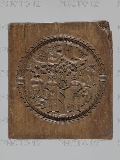 Double-sided gingerbread mould. Rectangular shape; obverse: man in 18th-century attire tricorn hat, justaucorps, culottes, long boots sitting on a goat, carved inscription at bottom: EIN SCHÖNER BOCK EIN GUTER / PFERD IST EINER GN ... DIE ZIGE WERT; complemented by plant and floral ornament. Reverse: Adam and Eve in Paradise wearing leaf loincloths, Tree of Knowledge with coiled serpent; at top a bearded figure holding an orb probably God against a heavenly vault with sun, moon and stars; animals around Adam and Eve include a cat, a deer, a bird, a cow, and a squirrel; composition surrounded by a round decorative frame with a plant twig. Materials/genre: gingerbread mould; style: folk-style decorations, floral and plant motifs, historical costumes, religious iconography original sin. Date: 18th–19th century. Place: Silesia Province 1742–1918. Dimensions: height 21.4 cm, width 24 cm, depth 3.7 cm., A rectangular wooden panel carved with a circular medallion containing decorative relief ...