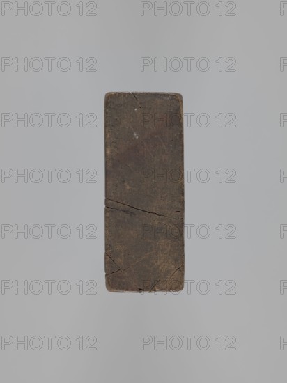 Double-sided gingerbread mold. Obverse: couple holding hands — a man and woman in 18th-century costume: woman in a richly decorated long dress with a hat, man in a caftan and short wig; decoration of plant elements at the bottom. Reverse: three empty rectangles. Woodcarving; applied art; genre scene with female and male figures and couples in love; rectangular. 18th–19th century, Province of Silesia 1742–1918. Height 20 cm, width 8.7 cm., A rectangular block with rounded corners, shown against a plain light gray background, exhibiting a dark brown surface with lighter brown and faint tan areas, visible hairline cracks and surface texture variations, and subtle darker spots and scuffs.