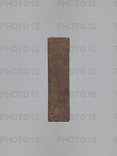 Double-sided gingerbread mould. Obverse: 16 images of various figures. Reverse: 12 depictions. Figurative motifs include male and female figures, birds, zoomorphic motifs, floral decorations, figurative scenes, and historical costumes. Double-sided rectangular mould; on one side sixteen small images depicting various human figures, male and female, arranged in four equal rows, shown from the front and from the back; the other side: twelve elements including two male figures on a rooster, another in peasant costume, presented in two views front and back; four different elements of clothing; two pipes decorated with tassels; two birds sitting on a flower-filled crater; and a column decorated with a flower garland with two birds on top. Gingerbread mould, applied art, folk motifs. 18th–19th century. Province of Silesia 1742–1918. Height 29.8 cm; width 13.8 cm; depth 3.8 cm., A vertical rectangular wooden block with a worn, textured surface suspended against a smooth light gray background;...
