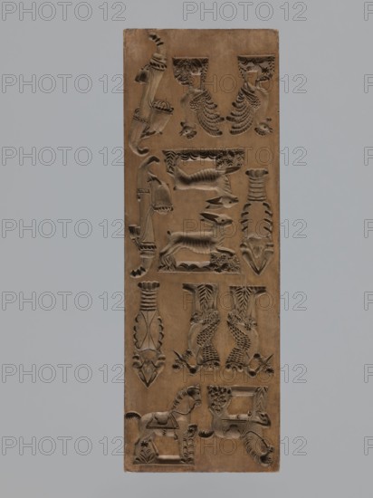Double-sided gingerbread mould, maker signed Glauer woodcarver or gingerbread maker, dated j.1827. Rectangle mould, height 29 cm, width 10.5 cm, depth 2.4 cm. One side: twelve small images of animals — two horses, two roosters, two crayfish, and two storks carrying babies in baskets — and two decorative pipes. Other side: miniature elements including children in swaddling blankets, shoes, footwraps, a cradle, a guitar, and additional motifs adorned with plant and geometric ornaments. Materials/genre: carved wooden form for gingerbread; folk motifs; zoomorphic and anthropomorphic figures; geometric and plant ornamentation. Silesia Province of Silesia, 1742–1918; dated 1826–1827., A vertical rectangular wooden panel carved with a repeating pattern of decorative relief motifs including stylized animals, birds, a horse, and abstract ornamental shapes, all in shades of brown; the background around the panel is a solid light gray.
