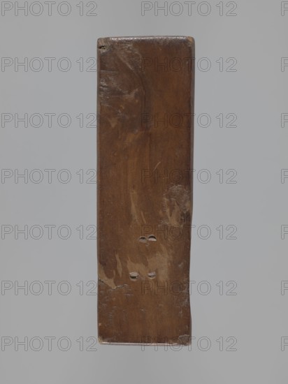Double-sided gingerbread mould; obverse: stylised elongated fish covered with scales, shown in profile; reverse: figure of Archangel Michael in a patterned robe decorated with a plant twig, holding scales in his right hand and a sword in his left, with a plant ornament at the bottom. Rectangular-shaped mould; material for gingerbread applied/decorative art; folk-style decorations; religious symbols; Silesia Province of Silesia, 1742–1918; 18th–19th century. Dimensions: height 13.5 cm, width 6.5 cm, depth 4.5 cm., A vertical rectangular piece of wood with a smooth, worn surface and rounded top edges, displaying a rich brown color with lighter brown patches and areas of darker brown grain; there are a few shallow dents and gouges, a couple of small paired depressions near the center, and subtle scratches and scuffs; the background is a uniform pale gray.