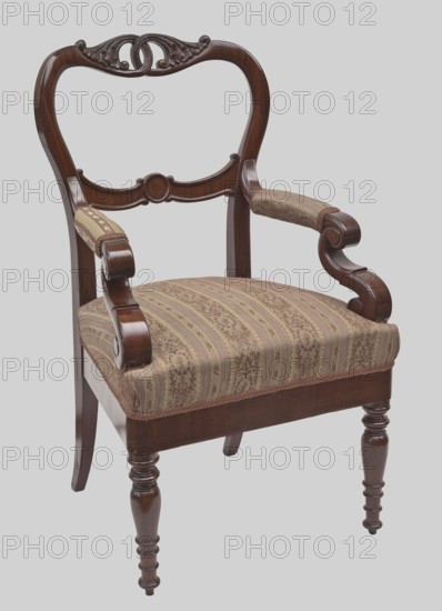Armchair, Jan Mohr fl. ca. 1825–1850 carpenter, floral decoration, Biedermeier style, mahogany. ARMCHAIR with a trapezoidal padded seat and an openwork, balloon-shaped backrest; turned, profiled front legs and angular rear legs arched backwards. Front legs shaped like a doll with rings at the bottom and a spool-shaped undercut at the top, on tapered feet. Straight, smooth frame with rounded front corners. Spring-mounted seat upholstered in fabric with wide and narrow stripes and a floral weave. S-shaped armrests and supports with padded armrests. Backrest stiles extend from the rear legs, rounded with central finials that merge into two interwoven tendrils with cup-shaped acanthus leaves. Backrest crosspiece formed by two arched links framing a circular field, edge accentuated with a half-cylinder, and mounted at the armrest junction. Date: 1840–1850. Place of origin: Kalisz. Type: seating furniture/furniture. Dimensions: H 102 cm, W 60 cm, D 60 cm., An upholstered wooden armchair with...