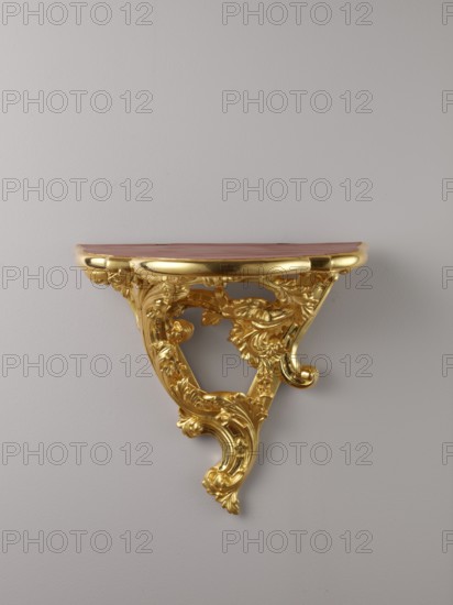 Hanging console, acanthus ornament, floral ornament, Rococo style, ca. mid-18th century, Central Europe, piece of furniture; height 37.3 cm, width 41.5 cm, depth 26 cm, A decorative wall-mounted shelf with ornate carved details and a glossy finish, featuring a curved top surface in a reddish-brown color and an intricately carved support structure in bright gold, set against a smooth light gray wall.