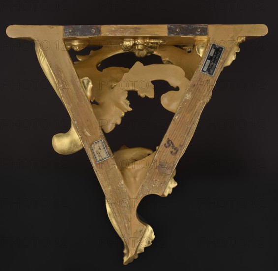 Hanging console, acanthus ornament, floral ornament, rococo style, ca. mid-18th century, Central Europe, piece of furniture, height 37.3 cm, width 41.5 cm, depth 26 cm, A triangular wooden decorative bracket with ornate carved scrollwork and leaf-like motifs in gold and natural wood tones against a dark background, showing worn surfaces and patches of darker patina, with a few small metal plates and fasteners attached, and visible variations of gold, brown, beige, and black.