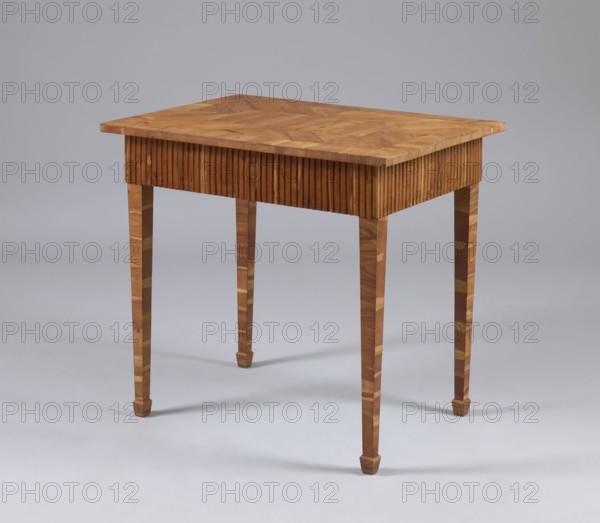 Table, snakes, rosettes ornament, plant decoration, classicism style, rectangular table with a drawer in a fluted frame, supported by four straight, angular, tapering legs terminating in wedge-shaped feet. Entire piece veneered with rosewood and polished. Tabletop has a straight, plate-shaped rim veneered in a cross pattern, with a rectangular central field and a narrow cross-frame, blintzed on the underside. Drawer handle is a knob formed of twisted rope with rosette plates. Drawers form a glued frame with sockets in the corners for mounting the leg tenons. Late 18th century, possibly Warsaw. Furniture; height 76.5 cm, width 84.2 cm, depth 59.5 cm., A wooden table stands on a light gray surface against a light gray background; the table has a rectangular top with a patterned wood grain in warm brown tones, a skirt with vertical slatted detailing in similar brown, and four tapered legs showing alternating lighter and darker brown wood grain, each terminating in a small faceted foot.