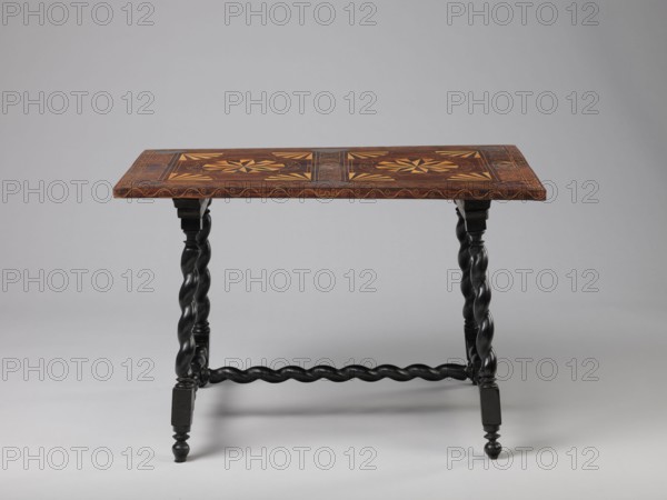 Table, geometric decorations, plant ornaments, rectangular table supported by four straight, spiral legs tilted outwards and sideways, joined at the bottom with an H-shaped tie and at the top with cross stiles connecting them in pairs. Cubes are located at the foot of the table. The tabletop is inlaid and covered with plant twigs and fans oval in the middle, quarters of an oval in the corners, halves halfway along the long sides; with a straight rim decorated with a wave motif. In the type of Baroque furniture from the 2nd half of the 19th century. 17th century, ca. 1660–1690, Spain, Flanders, piece of furniture, table, height 56.5 cm, width 83.7 cm, depth 53.8 cm, A wooden table with a rectangular top featuring intricate geometric inlay patterns in shades of brown and yellow sits on a pair of twisted black legs connected by a twisted black stretcher; the tabletop edge has a decorative border in brown and the legs end in turned black feet, all shown against a plain light gray backgroun...