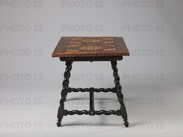 Table, geometric decorations, plant ornaments; rectangular table supported by four straight, spiral legs tilted outwards and sideways, joined at the bottom with an H-shaped tie and at the top with cross stiles connecting them in pairs. Cubes are located at the foot of the table. The tabletop is inlaid and covered with plant twigs and fan motifs oval in the middle, quarters of an oval in the corners, halves along the long sides; with a straight rim decorated with a wave motif. In the type of Baroque furniture from the 2nd half of the 17th century, ca. 1660–1690, possibly Spain or Flanders; piece of furniture table. Dimensions: height 56.5 cm, width 83.7 cm, depth 53.8 cm., A wooden table with a patterned rectangular top in shades of brown and tan and decorative darker brown borders sits against a plain light gray background; the tabletop shows geometric inlaid designs with lighter and darker wood tones and an edge with a wavy motif, supported by a group of dark brown to black twisted le...
