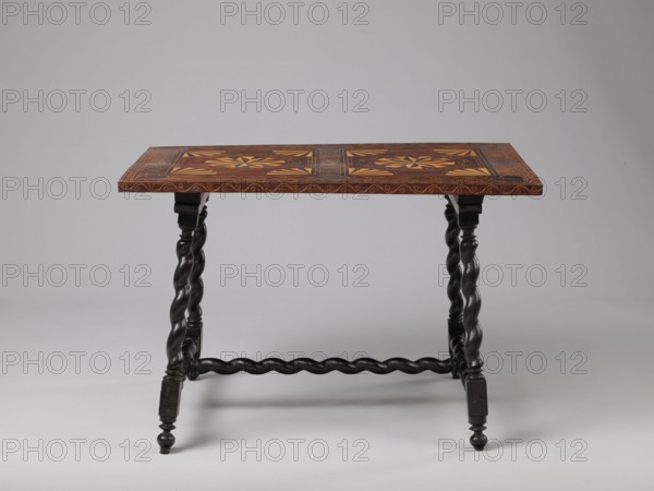 Table, geometric decorations, plant ornaments, rectangular table supported by four straight, spiral legs tilted outwards and sideways, joined at the bottom with an H-shaped tie and at the top with cross stiles connecting them in pairs. Cubes at the feet. The tabletop is inlaid and covered with plant twigs and fans oval in the middle, quarters of an oval in the corners, halves along the long sides; straight rim decorated with a wave motif. In the type of Baroque furniture from the 2nd half of the 17th century, ca. 1660–1690, Spain, Flanders . Piece of furniture, table; height 56.5 cm, width 83.7 cm, depth 53.8 cm., A wooden table with a rectangular top featuring inlaid geometric patterns in brown and lighter tan tones sits against a plain gray background; the table top has decorative edge detailing in a reddish-brown hue, and the base consists of dark, almost black twisted legs connected by a twisted stretcher, with turned feet and block elements.