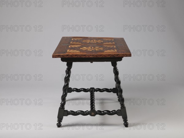 Table, geometric decorations, plant ornaments, rectangular table supported by four straight, spiral legs tilted outwards and sideways, joined at the bottom with an H-shaped tie and at the top with cross stiles connecting them in pairs. Cubes are located at the foot of the table. The tabletop is inlaid and covered with plant twigs and fans oval in the middle, quarters of an oval in the corners, halves halfway along the long sides; with a straight rim decorated with a wave motif. In the type of Baroque furniture from the 2nd half of the 19th century. 17th century, ca. 1660–1690, Spain, Flanders, piece of furniture, table, height 56.5 cm, width 83.7 cm, depth 53.8 cm, A wooden table with a square top featuring intricate geometric inlay in warm brown and tan tones sits on a set of dark, almost black, twisted legs and stretchers; the tabletop shows a patterned border and central decorative panels in shades of brown and golden tan, while the turned legs and connecting bars are deep black wit...