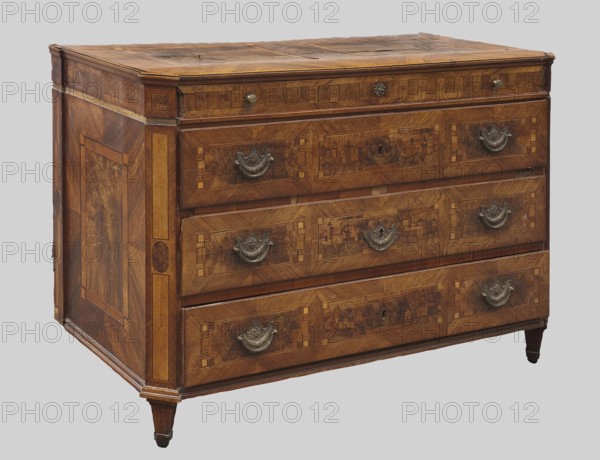 Chest of drawers, revindication provenance; decorated with roses, classicism style, vedute, geometric ornament, dolphins, eagles, rosettes; ca. 1790; Saxony; piece of furniture, storage piece; height 97 cm, width 143 cm, depth 62 cm., A wooden chest of drawers with a rectangular top and tapered legs, showing a rich brown wood grain with lighter and darker brown inlays and patterned marquetry; the front has three large drawers each with ornate metal handles in a dark metallic color and decorative keyhole escutcheons, and a narrower top drawer with small round metal knobs; the sides feature framed panel inlays and geometric border details in shades of brown and tan; the top surface shows irregularities in the wood tone and some darker brown areas; the overall colors visible are brown, tan, dark brown, and metallic gray.