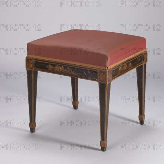 Stool, upholstered, covered with imitation black lacquer, with a square seat supported by four angular, tapering legs with glides. Decoration painted yellow, locally placed on an extruded ground — in a frame with plant and landscape motifs, rosettes on the ankles above the legs. The frame trim, frame edges and leg trims are painted gold. The seat is reupholstered with a red synthetic fabric, finished with an upholstery tape. Chinoiserie, birds, landscapes, rosettes ornament, classicism style. ca. 1800, Italy . Piece of furniture, seating piece. Height 48 cm, width 47.2 cm, depth 47.1 cm., A stool with a square padded seat upholstered in a muted red fabric sits on a wooden frame. The frame is painted dark brown or black with gold trim and decorative gold-painted landscape motifs on the apron. The legs are tapered and show vertical gold accents with small gold block details near the feet. The upholstery has a narrow gold braid along the lower edge. The visible colors are red, dark brown ...