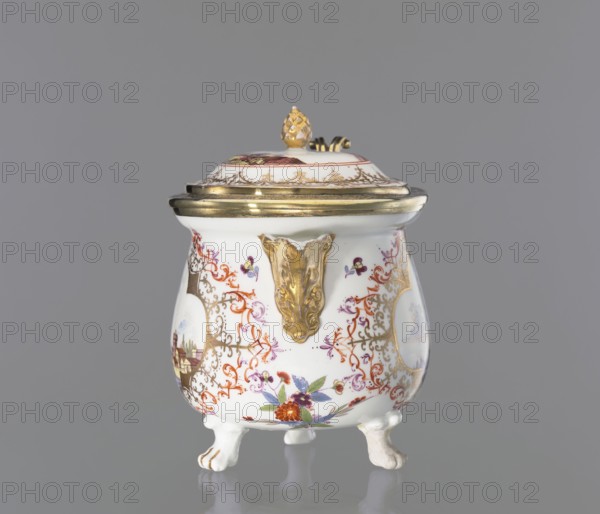 Milk jug, with lid, Augsburg city co-creator, Koenigliche Porzellain Fabrique, Meissen 1710-1763 author, Jug with a squat, spherical, slightly pear-shaped body with a collar around the edge, on three lion-paw legs, with an added triangular, gilded spout with leafy volutes at the base; S-shaped, ribbon-shaped handle, made of leafy, gilded rocaille sections. A slightly arched lid with a pinecone handle, in a gilded silver frame, mounted on a hinge at the rim of the jug. On the belly are two colorful miniatures: 1 a port scene with architecture on a high bank and staffage, 2 city walls over water, with a stone bridge, a boat, and staffage on the bridge. The miniatures are set in 4-leaf gilded lace frames, complemented by a brick-red and purple Regency ornament. Under the spout, beside it, and next to the handle are twigs and projections of Indianische Blumen. On the lid, two port scenes are inscribed in a brick-red circle; a trail of gilded lace surrounds the miniature. Gilded handles, sp...