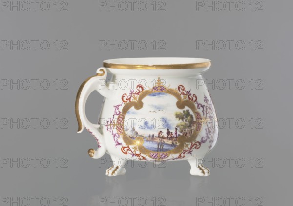 Lion's paw cream pot with miniatures, Meissen porcelain factory, ca. 1730. Porcelain whipped-cream pot with squat belly and wide collar; volute, segmental handle gilded along the spine; on three legs shaped as lion’s paws. Body decorated with three oval/quadrangular reserves surrounded by a gilded frame with ovals of colorful Chinese latticework and purple-brick-red leaf motifs and Regency volutes—each reserve with colorful landscape miniatures by the water with staffage: 1 a barrel-wheeler and four men at the quay; 2 two men with cargo at the shore and a woman and three men standing nearby; 3 four men waiting with luggage and sailing boats at the shore. Between the miniatures, two brick-purple Regency compositions with gilding; lion’s paws and outer edge of the collar gilded. Saxony, Meissen, Germany., A white porcelain cup with a curved handle and three small clawed feet, decorated with gold trim and gold accents on the handle and feet, features an ornate framed scene painted on its ...