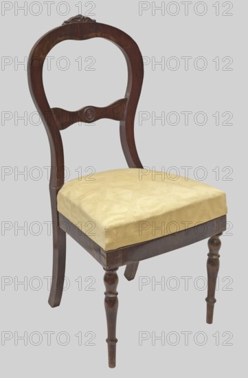 Chair, plant decoration, knobs ornament, Biedermeier, Louis Philippe, 1835–1845, Warsaw, piece of furniture, seating piece, height 105 cm, width 48.5 cm, depth 49.5 cm, A wooden chair with a curved backrest and a decorative carved crest, featuring a dark brown finish, a carved horizontal support in the back with a rounded central motif, a padded seat covered in pale yellow fabric, turned front legs and straight rear legs, all shown against a pale gray background.