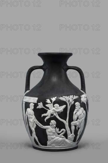 Portland Vase, copy, Josiah Wedgwood & Sons Stoke-on-Trent; pottery manufactory; 1790–1895. Pelike-shaped vase in black with white reliefs white rendered from a black background depicting: 1 Atia, mother of Emperor Augustus, Apollo and Neptune; 2 Hecuba wife of Priam holding a torch, surrounded by Venus and Paris. At the bottom, Paris, lost in thought. 19th/20th century. Staffordshire, Stoke-on-Trent, England. Vase. Height 26.6 cm; width 19 cm. Maker: Wedgwood, Josiah 1730–1795., A dark vase with a wide neck and two handles features raised white relief figures and foliage around its lower body; the relief shows a reclining figure, a few standing figures with draped cloths, and a winged cherub among stylized trees and leaves. The vase is primarily black with white decorative elements, set against a neutral gray background.