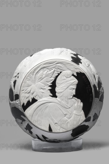 Portland Vase, copy, Josiah Wedgwood & Sons Stoke-on-Trent; pottery manufactory; 1790–1895. Pelike-shaped vase in black with white rendered from a black background reliefs depicting: Atia, mother of Emperor Augustus, Apollo and Neptune; Hecuba wife of Priam with a torch in her hand, surrounded by Venus and Paris; at the bottom, Paris, lost in thought. 19th/20th century. Staffordshire, Stoke-on-Trent, England. Vase; height 26.6 cm, width 19 cm., A round decorative object sits on a clear stand against a gray background, the object showing a raised profile of a person wearing a draped head covering and cloak, with a contemplative hand near the face and stylized leaf motifs behind the head; the object has contrasting dark and light areas in a patterned arrangement, and the visible colors include gray, white, black, and clear.