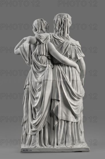 Two princesses, the so-called Prinzessinnengruppe, Koenigliche Porzellan Manufaktur KPM; Berlin; 1763-1918, Schadow, Johann Gottfried 1764-1850 sculptor, Schadow, Gottfried Johann sculptor; 1764-1850, revindication provenance, Luise von Mecklenburg-Strelitz 1776-1810, Friedrich von Mecklenburg-Strelitz 1778-1841, double portraits, portraits. On a flat rectangular base, two young women, arms around each other in long, antique-looking dresses made of thin fabric, draped under the bust Luiza, in sandals, with curling, parted mid-length hair. Luiza puts her arm around her sister, resting her hand on her left shoulder; with her right, lowered hand, she supports the folds of her dress. Fryderyka embraces her sister from behind around the waist, her left hand grasping her sister's arm, which is resting on her shoulder. Ca. 1795/1796, Germany, Berlin. Sculpture; height 55.0 cm, width 35 cm, depth 19.5 cm., A grayscale image of a sculpted marble statue showing the back view of two standing figu...