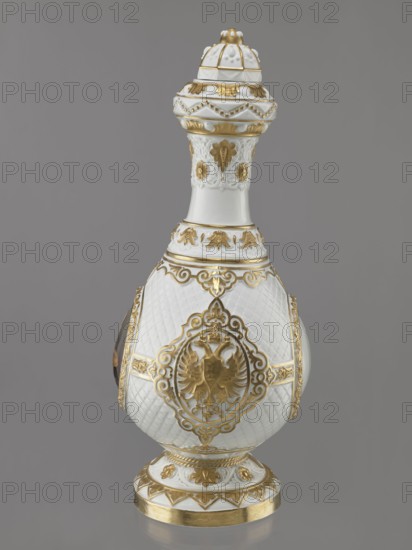 Bottle-shaped vase with a domed lid. Imperial Porcelain Factory in St. Petersburg 1744–1917; modeler: August Karlowicz Spiess 1817–1904. Embossed and colorfully painted decoration with four medallions set against a rococo latticework: a miniature portrait of Tsar Alexander II in ceremonial military uniform with epaulettes and a blue ribbon, the Tsar's monogram, and the Tsar's double-headed eagle. Gilded floral and plant elements. Condition: gap at the base, worn gilding. 1869, St. Petersburg, Russia. Porcelain vessel; height 49.5 cm, width 22 cm., A decorative porcelain vessel with a bulbous body, a tall neck, and a domed lid, all in white with extensive gold ornamentation; the surface shows a quilted texture on the body and raised floral and scroll motifs in gold, with a circular medallion-like decoration featuring a gold double-headed bird motif on the front; the neck and lid have embossed floral designs and beaded gold borders, and the footed base is white with gold bands and styliz...