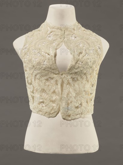 Bodice, lace, bodices, women's clothing, fashion. In a pattern of rosettes connected by large spiders and heads. Pattern of stylized floral motifs. 19th century, France. Clothing accessory. Height 36 cm, circumference 63 cm., A dress form mannequin in off-white displays a sleeveless, cropped lace bodice in a pale cream color with an open keyhole front and scalloped edges, featuring an intricate floral and swirling cutwork lace pattern with areas of sheer netting and denser embroidered motifs; the mannequin stands against a neutral gray background, and the visible colors include cream, off-white, pale beige, and gray.