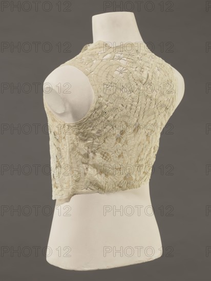 Bodice, lace, provenance, bodice for women's clothing; In a pattern of rosettes connected by large spiders and heads; Pattern of stylized floral motifs; 19th century, France; clothing accessory; height 36 cm, circumference 63 cm., A dress form in off-white displays a sleeveless lace bodice in a pale cream color with an intricate floral and geometric openwork pattern; the mannequin has a smooth matte surface in off-white and is set against a solid muted gray background, showing the bodice from a rear three-quarter view with the lace edges and subtle variations of cream and beige visible.