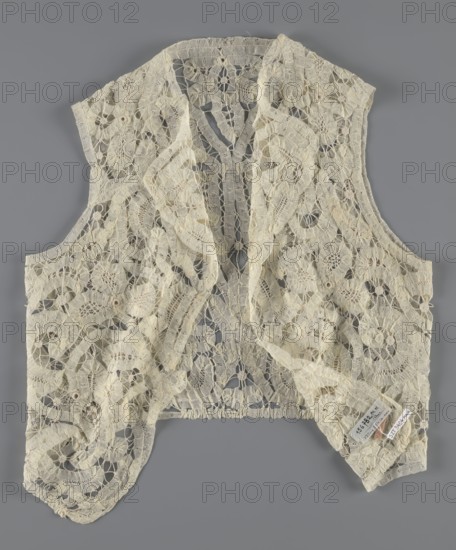 Bodice, lace, provenance, bodice for women's clothing; In a pattern of rosettes connected by large spiders and heads. Pattern of stylized floral motifs. 19th century, France; clothing accessory; height 36 cm, circumference 63 cm, A delicate lace vest laid flat on a gray background, made from cream-colored lace with an intricate openwork pattern of floral and circular motifs connected by narrow lace bridges, featuring scalloped edges and a softly ruffled front opening, with areas of slight irregularity in the weave and a few small tags tucked near one lower edge.