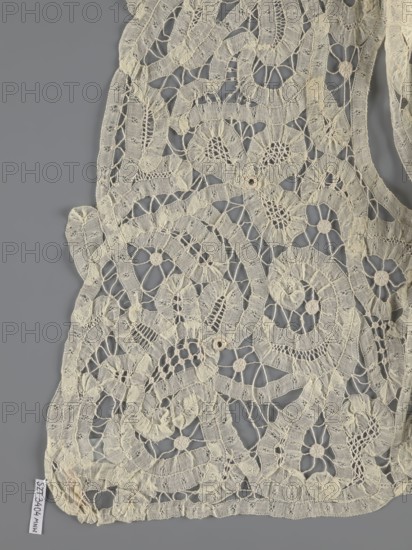 Bodice, lace, provenance unknown, bodices, women's clothing, fashion. In a pattern of rosettes connected by large spiders and heads. Pattern of stylized floral motifs. 19th century, France. Clothing accessory. Height 36 cm, circumference 63 cm., A delicate piece of openwork fabric with an intricate lace pattern lies against a gray background, showing a network of floral and circular motifs connected by narrow, textured bands and mesh-like stitches; the lace is a pale cream color with subtle variations in shade, and the background is a uniform medium gray.