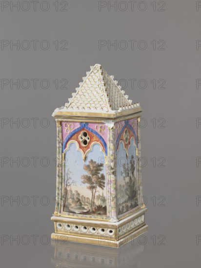 Night Lamp, Popow, Alexander porcelain manufacturer; 1806–1872 author, lamps, landscapes with architecture. Neo-Gothic, plant motifs. Lamp composed of three parts: base, lamp, and cover. Base with a horizontal row of holes on each side creating a decorative trail. Lamp in the form of a cube, in the neo-Gothic style; arcades with tracery painted with colorful landscapes: two with motifs of flowering bushes primrose and jasmine, floral motifs against landscape backgrounds, and two landscapes with architectural motifs. 19th century, Russia, Gorbunovo. Lamp, height 32.2 cm, width 13 cm., A decorative tower-shaped object with a pointed tiled roof in white and gold sits against a plain gray background; the body of the object shows painted panels framed by ornate borders in colors including pink, purple, blue, gold, white, and green, with landscape scenes featuring trees and foliage visible on the panels and stylized floral motifs on adjacent faces; the base is rectangular with a band of circ...
