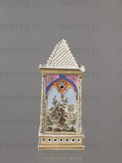 Night Lamp, Popow, Alexander porcelain manufacturer; 1806–1872 author, lamps, landscapes with architecture, neo-Gothic style, plant motifs. Lamp composed of three parts: base, lamp, and cover. Base with a horizontal row of holes on each side creating a decorative trail. Lamp in the form of a cube in the neo-Gothic style; arcades in the shape of tracery painted with colorful landscapes: two with motifs of flowering bushes primrose and jasmine, floral motifs against the background of a landscape, two landscapes with an architectural motif. 19th century, Russia, Gorbunovo. Lamp; height 32.2 cm, width 13 cm., A decorative ceramic tower with a pointed, white roof patterned with scallop-like ridges and edged in gold sits against a gray background; the rectangular body displays painted panels framed by marbled pastel columns in pink and green, a central panel showing a delicate landscape with a flowering plant and distant trees in muted greens, browns, and blues, topped by an arched canopy in...