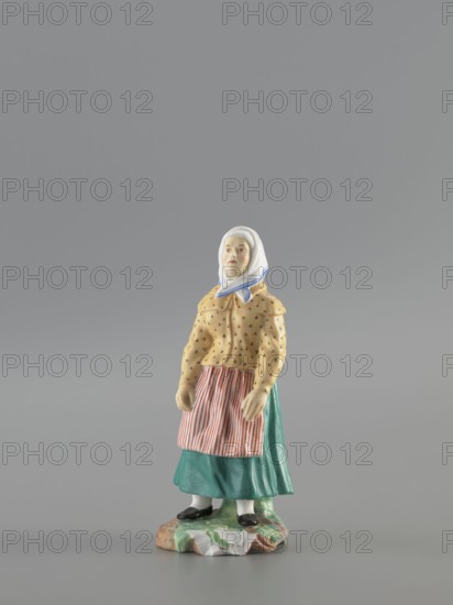 Figurine: Peasant Woman, Popov, Alexander porcelain factory; 1806–1872 author, figurines. Figurine depicting a woman in a white scarf with a blue border on her head, wearing a green skirt and apron with red stripes, a yellowish caftan with black dots. Base missing. 1830–1840, Russia, Gorbunovo. Height 3.5 cm, width 6.0 cm, depth 5.7 cm., A small ceramic figurine of a woman standing on an irregularly shaped base, wearing a white headscarf with a blue trim, a yellow blouse with a small dark pattern, a green skirt, and a striped apron in red and white; she has pale skin, painted facial features, white stockings, and black shoes, and the base shows mottled colors including green, brown, and white, all set against a plain gray background.