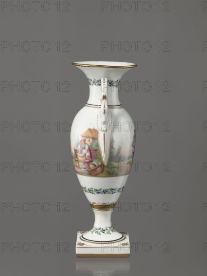 Amphora vase, Imperial Porcelain Factory in St. Petersburg early 19th century, Russia. Ovoid body with a slender neck that flares upward, slender tall foot on a square plinth, two handles in the form of swans. Neck, foot, and lower body decorated with a colorful trail of small flowers. On the belly, two miniatures depicting rural landscape scenes: a woman doing laundry, leaning over a tub of laundry placed on a low table while a man with a dog watches; and two men with their arms around each other, one holding a bottle, the third leaning forward in the background. Porcelain, genre miniatures; height 26.5 cm, width 11.0 cm, depth 9.0 cm., A white porcelain vase with a flared rim and a pedestal base stands against a neutral gray background; the rim, handle, and several bands are gilded in gold, and there are painted floral garlands in blue and green around the neck and lower body. The body features a painted rural scene showing a woman near a thatched cottage and wooden cart amid greener...